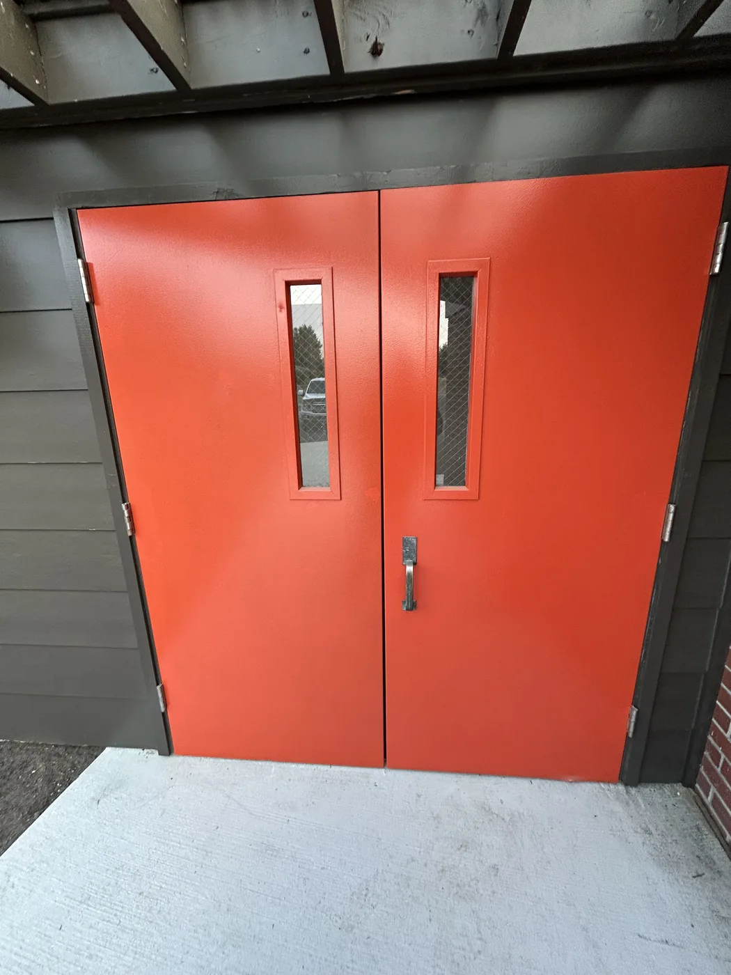 New commercial steel double doors installed and painted in Fircrest, WA, with wire-glass vision lites